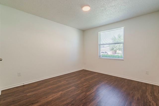 1423 Queen Annes Dr, Burleson, TX 76028 - empty room featuring dark wood-type flooring, baseboards, and a textured ceiling
