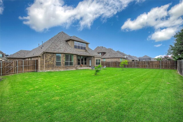 1328 Sandpiper Dr, Forney, TX 75126 - rear view of property with brick siding, roof with shingles, and a patio area