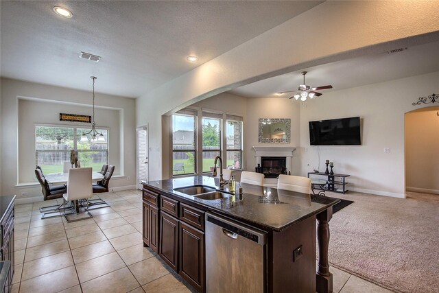 1328 Sandpiper Dr, Forney, TX 75126 - kitchen featuring stainless steel dishwasher, a sink, open floor plan, a glass covered fireplace, and ceiling fan
