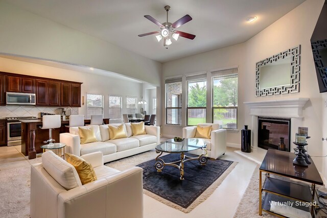 1328 Sandpiper Dr, Forney, TX 75126 - living room featuring plenty of natural light, ceiling fan, a glass covered fireplace, and light tile patterned flooring