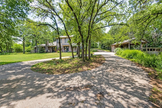1467 Limerick Ct, Keller, TX 76262 - view of front of house with curved driveway, a front lawn, and view of wooded area
