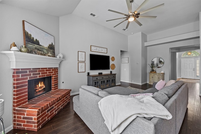 712 Saint Robby Dr, Mansfield, TX 76063 - living room with dark wood-type flooring, ceiling fan, a brick fireplace, baseboards, and high vaulted ceiling