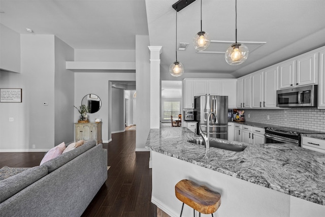 712 Saint Robby Dr, Mansfield, TX 76063 - kitchen featuring stainless steel appliances, light stone countertops, white cabinets, a sink, and decorative backsplash