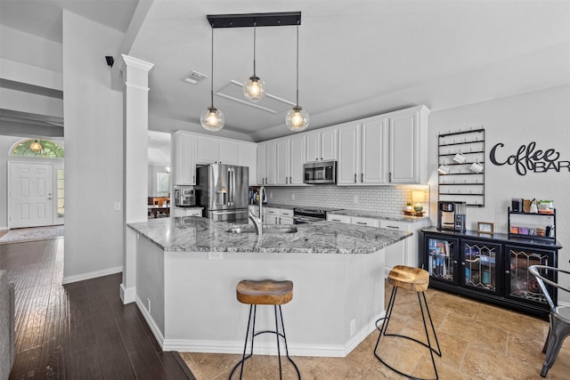 712 Saint Robby Dr, Mansfield, TX 76063 - kitchen featuring stainless steel appliances, a sink, white cabinets, light stone countertops, and tasteful backsplash
