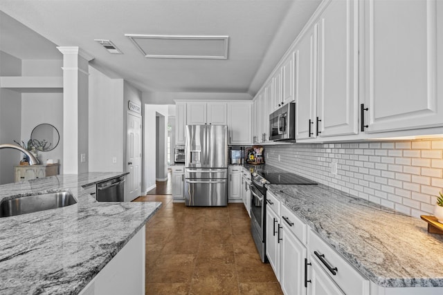 712 Saint Robby Dr, Mansfield, TX 76063 - kitchen featuring stainless steel appliances, a sink, white cabinets, and light stone counters