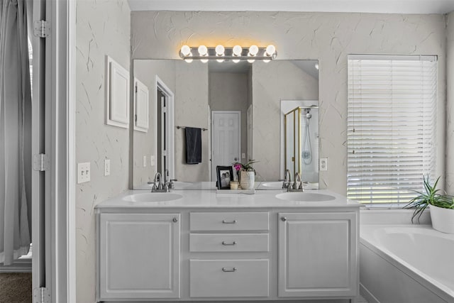 712 Saint Robby Dr, Mansfield, TX 76063 - bathroom featuring double vanity, a bath, a shower stall, and a textured wall