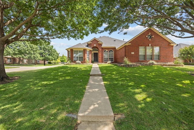 712 Saint Robby Dr, Mansfield, TX 76063 - traditional-style home featuring a front yard, brick siding, and a shingled roof