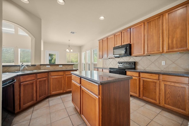 700 Sage Brush Dr, Weatherford, TX 76087 - kitchen with black appliances, a sink, brown cabinets, decorative backsplash, and recessed lighting