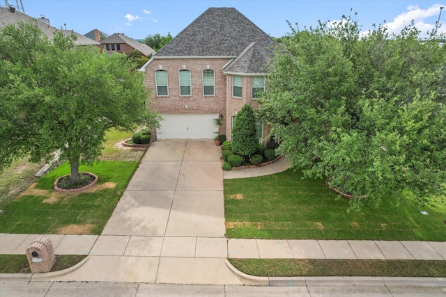 700 Sage Brush Dr, Weatherford, TX 76087 - view of front of home featuring concrete driveway, a shingled roof, an attached garage, a front lawn, and brick siding