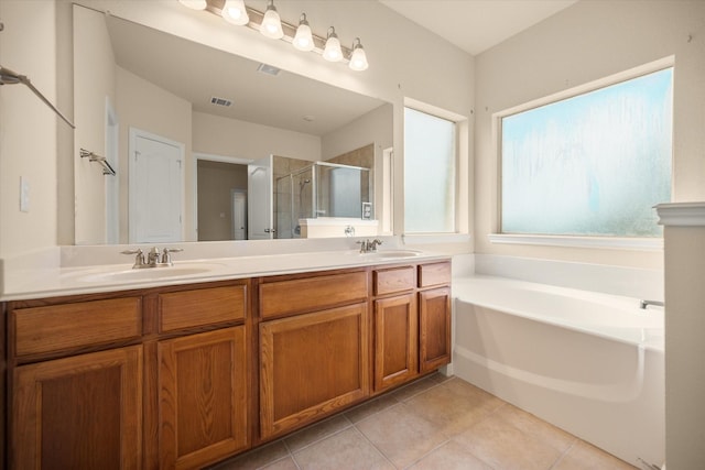 700 Sage Brush Dr, Weatherford, TX 76087 - full bathroom with a shower stall, double vanity, tile patterned flooring, and a bath