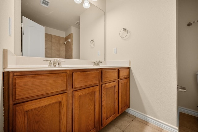 700 Sage Brush Dr, Weatherford, TX 76087 - full bath with double vanity, tile patterned floors, baseboards, and a tile shower