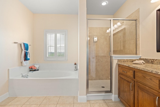 706 E 1st St, Fort Worth, TX 76102 - full bath featuring a garden tub, a shower stall, vanity, tile patterned flooring, and baseboards