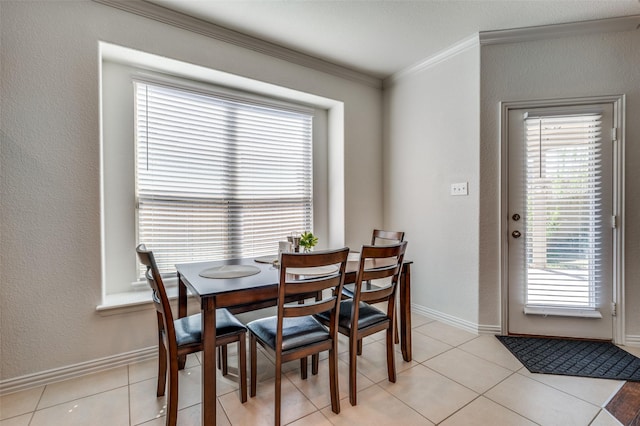 11812 Patton Dr, Frisco, TX 75036 - dining space with crown molding, plenty of natural light, light tile patterned floors, and baseboards