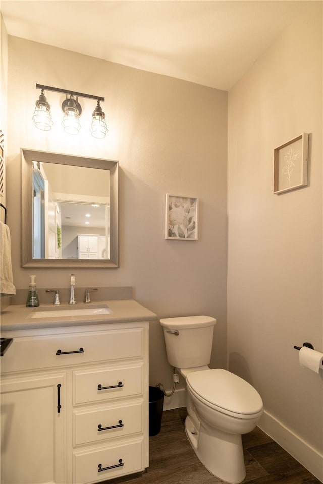 4721 Dry Creek Rd, Sherman, TX 75092 - half bath with toilet, wood finished floors, vanity, and baseboards