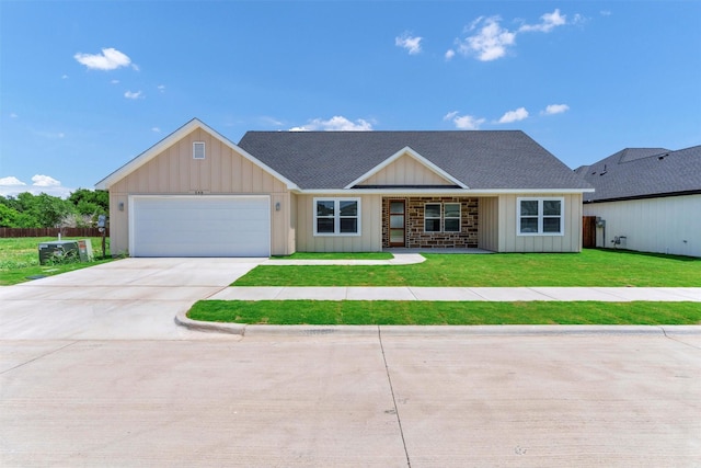 548 Highview Ct, Godley, TX 76044 - view of front facade featuring an attached garage, driveway, board and batten siding, a front yard, and roof with shingles