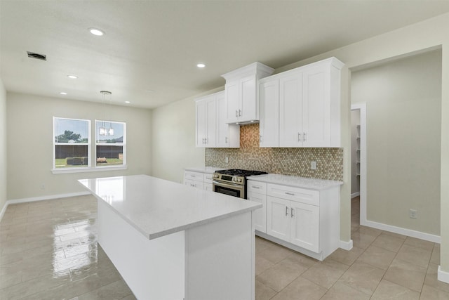 548 Highview Ct, Godley, TX 76044 - kitchen with stainless steel range with gas cooktop, light countertops, backsplash, a kitchen island, and recessed lighting