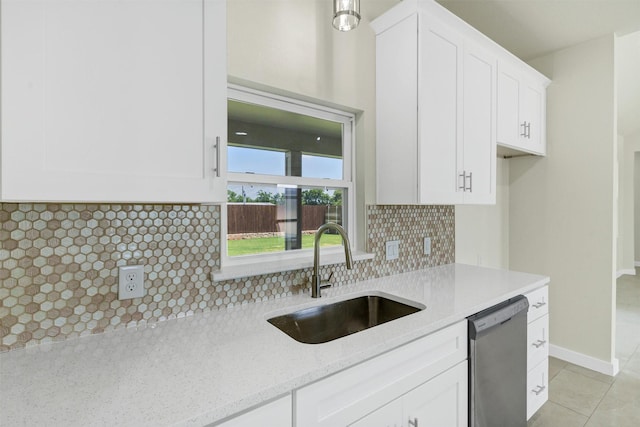 548 Highview Ct, Godley, TX 76044 - kitchen featuring stainless steel dishwasher, a sink, white cabinetry, light stone countertops, and backsplash