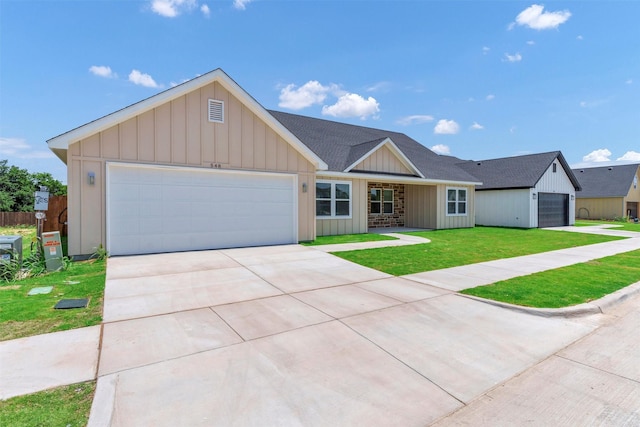 548 Highview Ct, Godley, TX 76044 - view of front of home featuring board and batten siding, a front lawn, an attached garage, concrete driveway, and a shingled roof