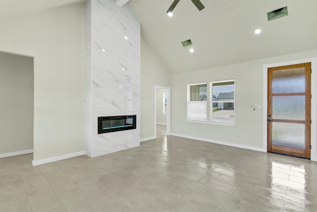 548 Highview Ct, Godley, TX 76044 - unfurnished living room featuring high vaulted ceiling, baseboards, a high end fireplace, a ceiling fan, and recessed lighting