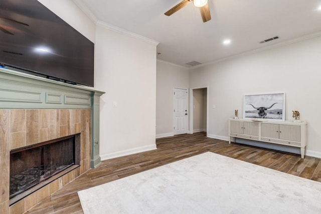 6637 Oakmont Ct, Plano, TX 75093 - unfurnished living room with a ceiling fan, crown molding, wood finished floors, a tile fireplace, and baseboards