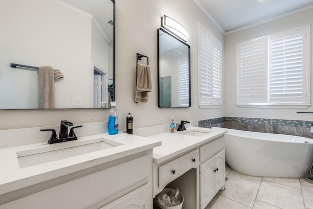 6637 Oakmont Ct, Plano, TX 75093 - bathroom featuring ornamental molding, double vanity, a freestanding bath, and tile patterned floors