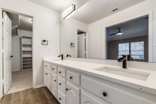 6637 Oakmont Ct, Plano, TX 75093 - bathroom featuring double vanity, wood finished floors, ceiling fan, and baseboards