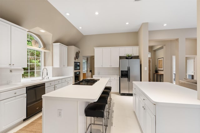 110 San Mateo Ct, Allen, TX 75013 - kitchen with a center island, black appliances, a sink, decorative backsplash, and recessed lighting