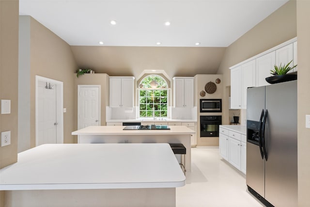 110 San Mateo Ct, Allen, TX 75013 - kitchen featuring black appliances, lofted ceiling, white cabinetry, light countertops, and recessed lighting