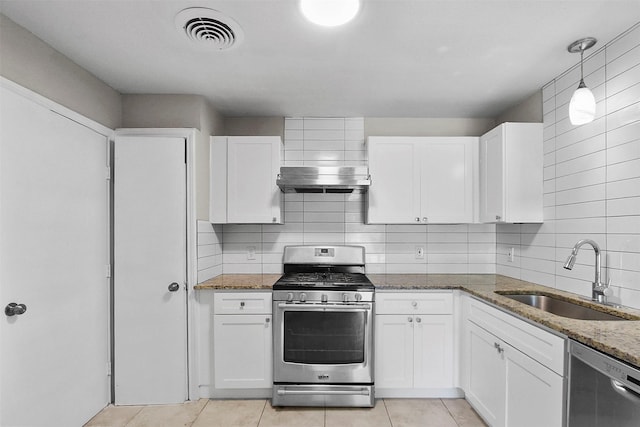 11022 Desdemona Dr, Dallas, TX 75228 - kitchen featuring stainless steel appliances, a sink, dark stone counters, light tile patterned floors, and white cabinets