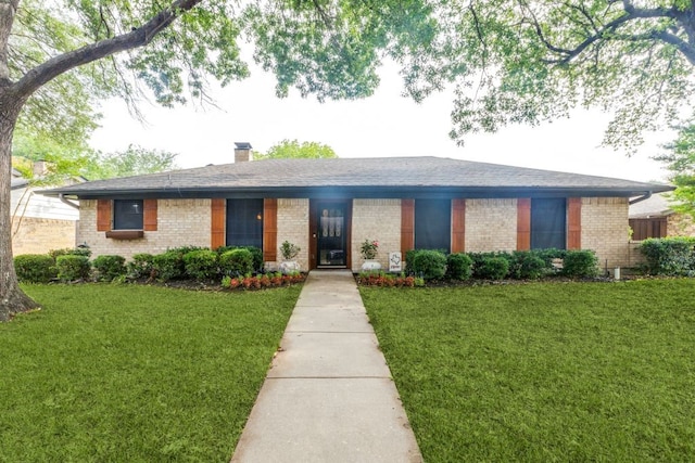4937 Willowhaven Cir, Garland, TX 75043 - view of front of property with brick siding, a front yard, a chimney, and a shingled roof