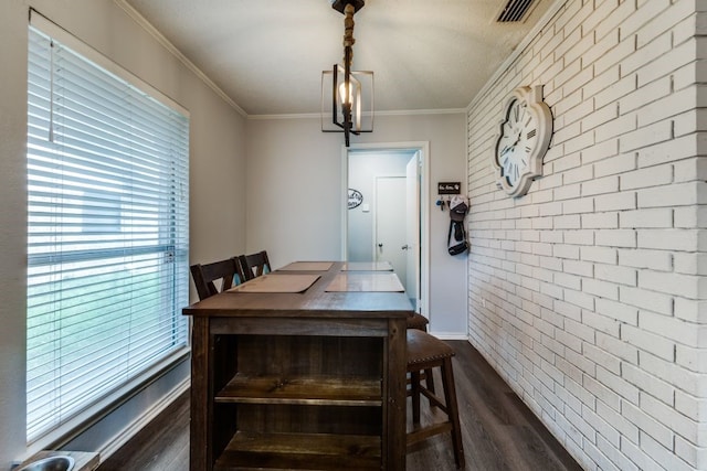 4937 Willowhaven Cir, Garland, TX 75043 - dining area with dark wood-style flooring, brick wall, ornamental molding, baseboards, and a chandelier