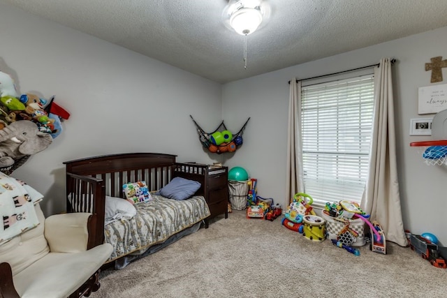 4937 Willowhaven Cir, Garland, TX 75043 - bedroom featuring carpet flooring and a textured ceiling