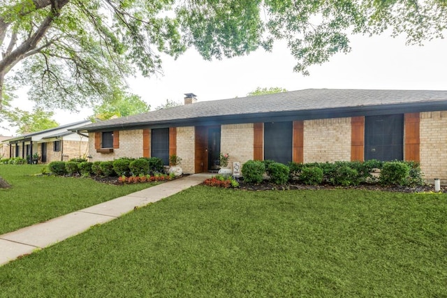 4937 Willowhaven Cir, Garland, TX 75043 - ranch-style home with brick siding, a front yard, a chimney, and roof with shingles