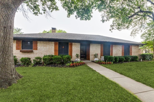 4937 Willowhaven Cir, Garland, TX 75043 - view of front of house with a chimney, brick siding, and a front yard