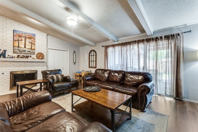 4937 Willowhaven Cir, Garland, TX 75043 - living area featuring a textured ceiling, wood finished floors, a brick fireplace, and ceiling fan