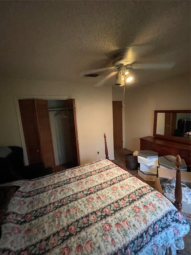 6320 Bocage Dr, Shreveport, LA 71119 - carpeted bedroom with a textured ceiling, a closet, and a ceiling fan
