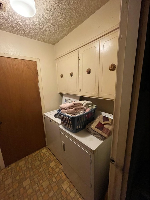 6320 Bocage Dr, Shreveport, LA 71119 - laundry room with cabinet space, washer and dryer, and a textured ceiling