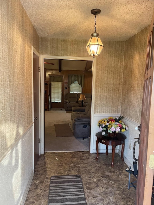 6320 Bocage Dr, Shreveport, LA 71119 - hallway with wallpapered walls and a textured ceiling