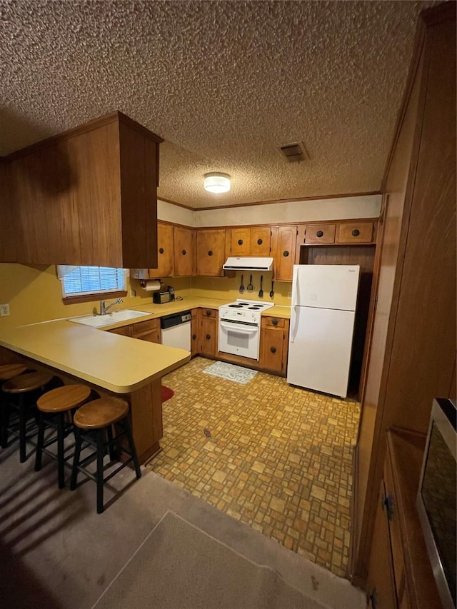 6320 Bocage Dr, Shreveport, LA 71119 - kitchen with white appliances, exhaust hood, a peninsula, light countertops, and a sink