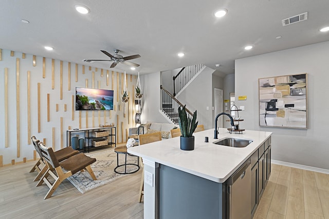 3701 Star Mesa Unit 14, Heartland, TX 75114 - kitchen with a sink, stainless steel dishwasher, light wood-style flooring, a ceiling fan, and baseboards