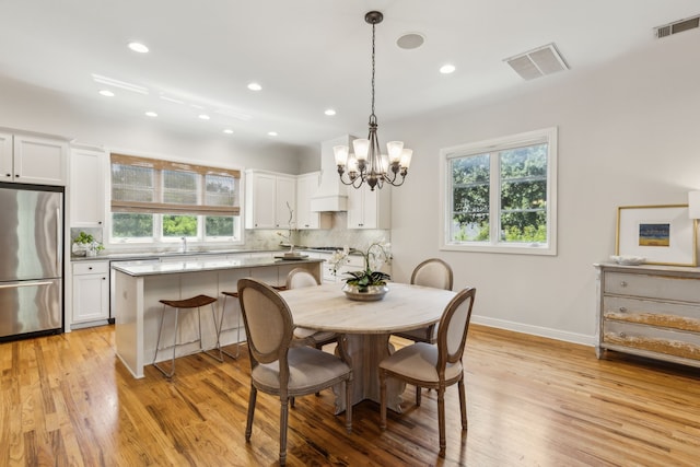 275 Casa Blanca Ave, Fort Worth, TX 76107 - dining space featuring healthy amount of natural light, light wood-style floors, a chandelier, baseboards, and recessed lighting