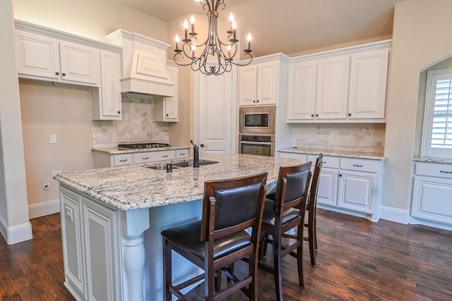 2230 Lewis Canyon Dr, Prosper, TX 75078 - kitchen with appliances with stainless steel finishes, a sink, a chandelier, baseboards, and white cabinetry