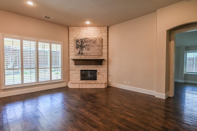 2230 Lewis Canyon Dr, Prosper, TX 75078 - unfurnished living room featuring baseboards, dark wood finished floors, a fireplace, arched walkways, and recessed lighting