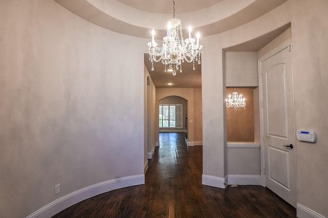 2230 Lewis Canyon Dr, Prosper, TX 75078 - hall with a chandelier, arched walkways, dark wood finished floors, and baseboards
