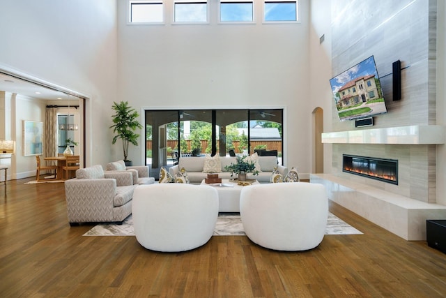 6807 Orchid Ln, Dallas, TX 75230 - living area featuring a towering ceiling, wood finished floors, and a fireplace
