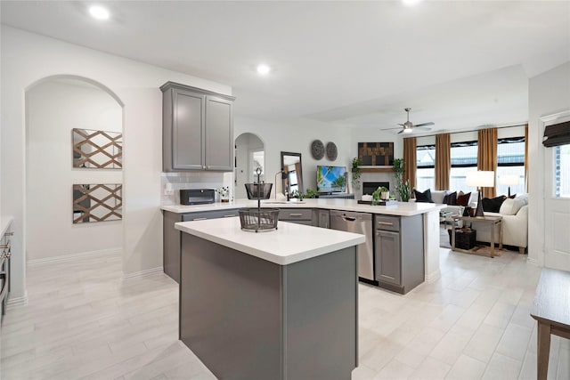 911 Bluewood St, Princeton, TX 75407 - kitchen featuring gray cabinets, stainless steel dishwasher, arched walkways, a peninsula, and a ceiling fan