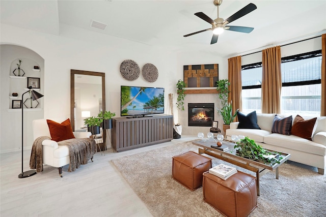 911 Bluewood St, Princeton, TX 75407 - living area featuring wood finished floors, a tiled fireplace, a ceiling fan, and baseboards