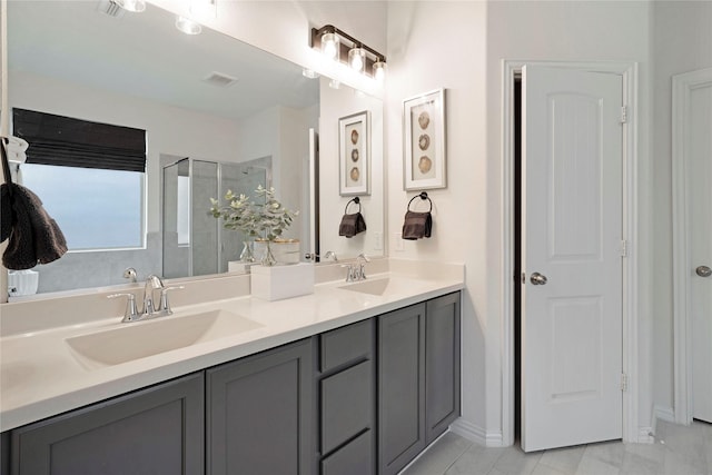 911 Bluewood St, Princeton, TX 75407 - full bathroom with double vanity, a shower stall, and baseboards