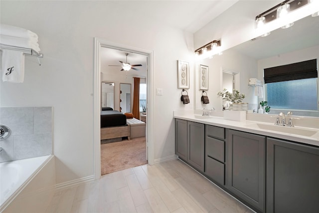 911 Bluewood St, Princeton, TX 75407 - full bath featuring ensuite bath, double vanity, a tub to relax in, a ceiling fan, and wood finished floors