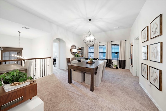 911 Bluewood St, Princeton, TX 75407 - dining room featuring a chandelier, light colored carpet, and arched walkways